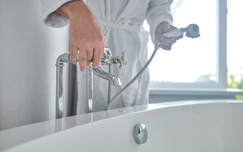 a person is install the bathroom faucet