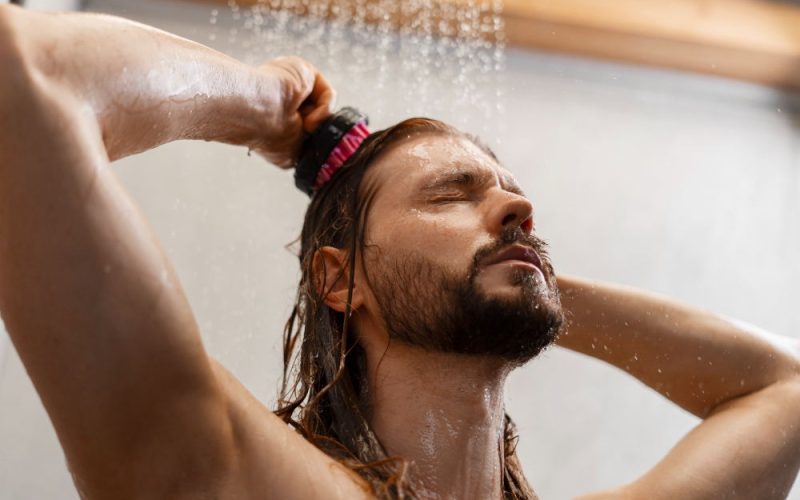 A man using the bathroom faucet