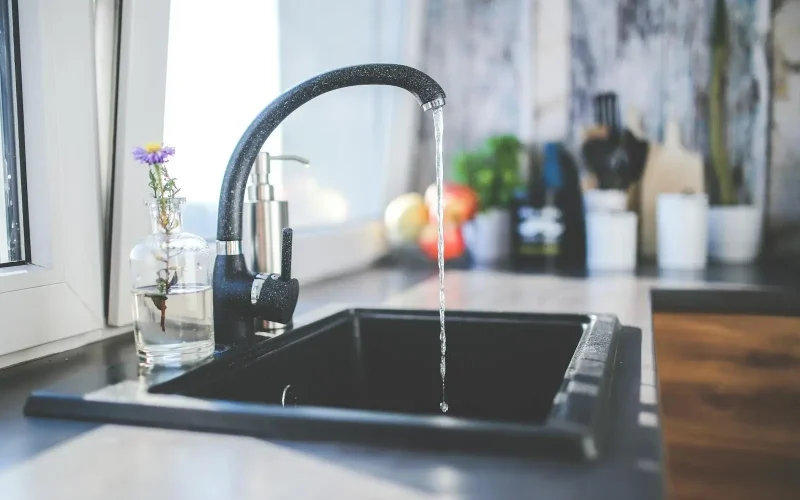 Black sink with running water